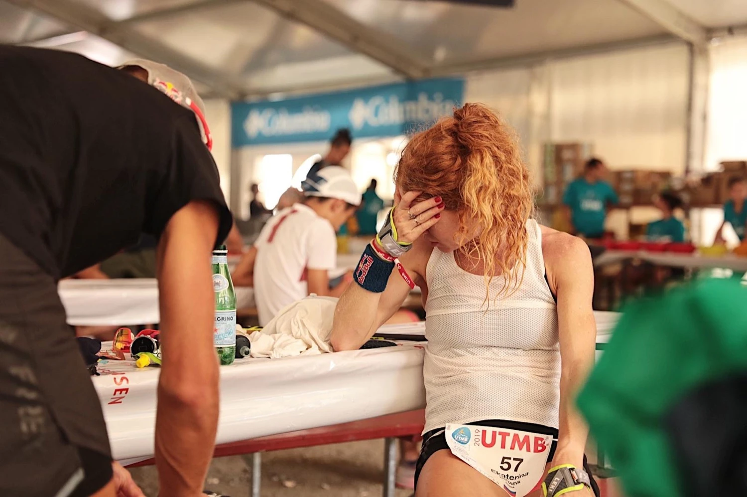 Female athlete at an aid station with water